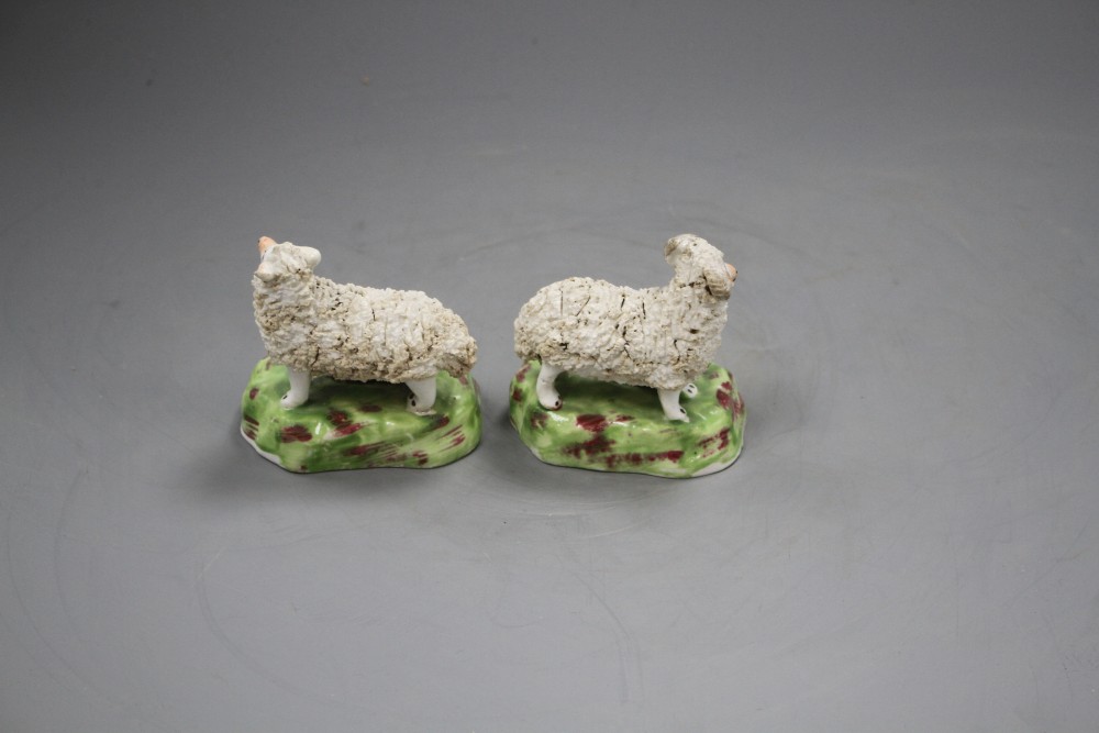 A pair of Staffordshire porcelain groups of sheep and lambs, c.1840-50, L. 7.4cm